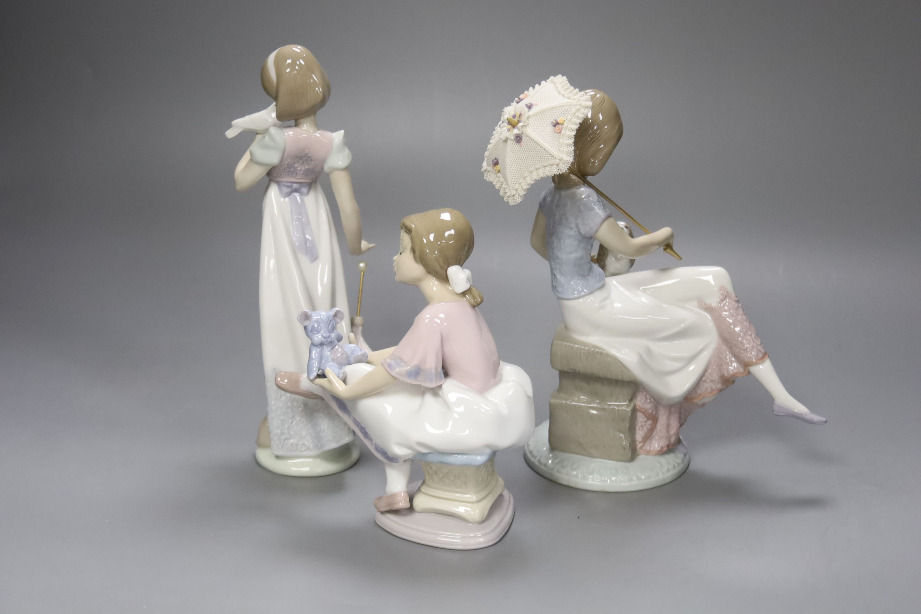 A Lladro figurine 'Best Friend', 'Summer Stroll' and 'Picture Perfect', tallest 22cm